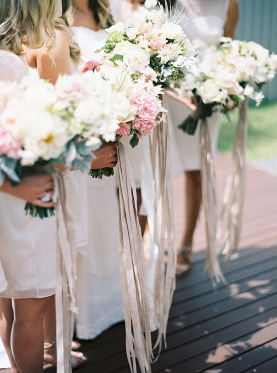 Bridesmaid bouquets with long silk ribbons