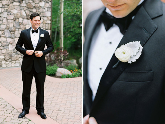 Elegant groom in black tuxedo with white boutonniere