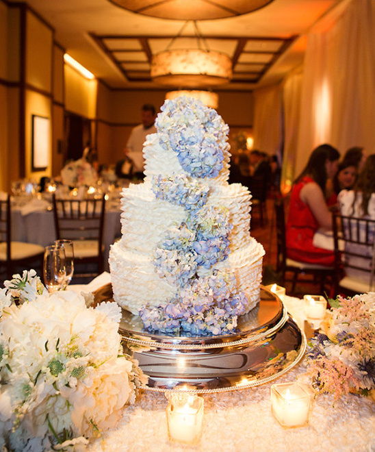 Three tier wedding cake with blue hydrangea flowers