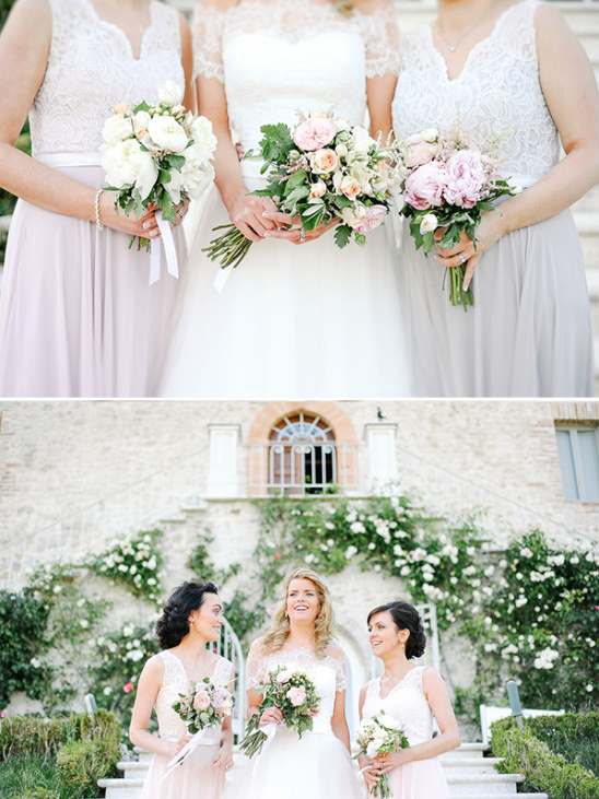 Bride and bridesmaids holding flower bouquets outdoors