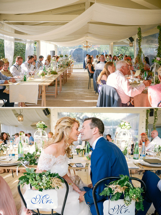 Bride and groom at a rustic wedding reception table