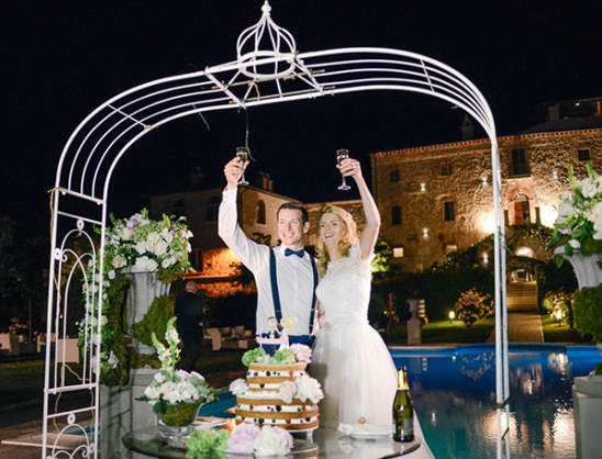 Bride and groom toasting at outdoor wedding reception