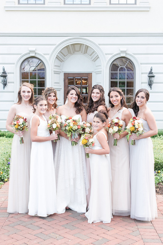 Bride with bridesmaids and flower girls at wedding