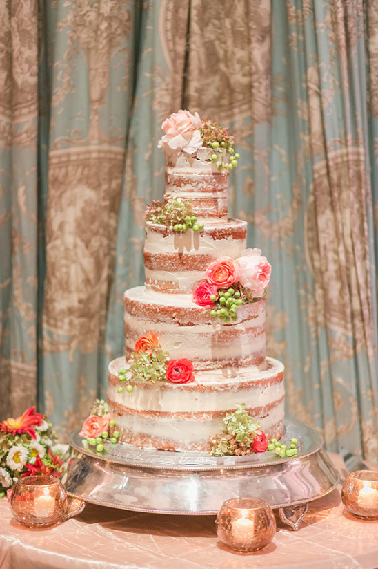 Elegant five tiered naked wedding cake with floral accents