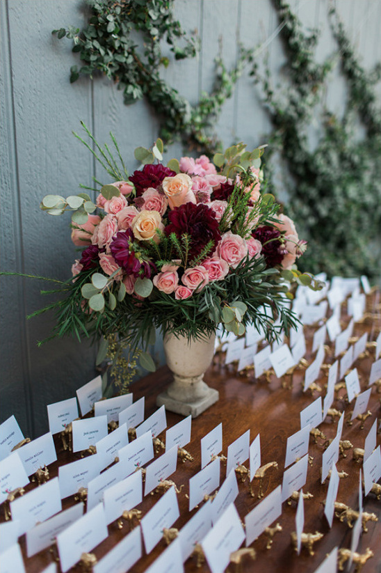 Wedding place cards with floral centerpiece detail