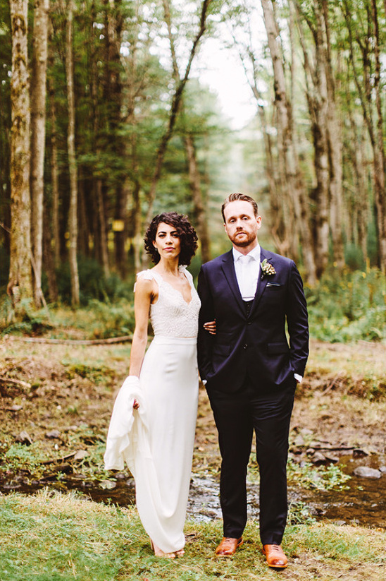 Bride and groom pose in a forest wedding photo