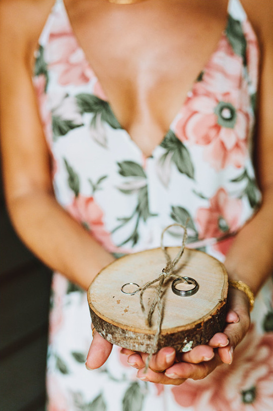 Bride holding rustic wooden ring bearer