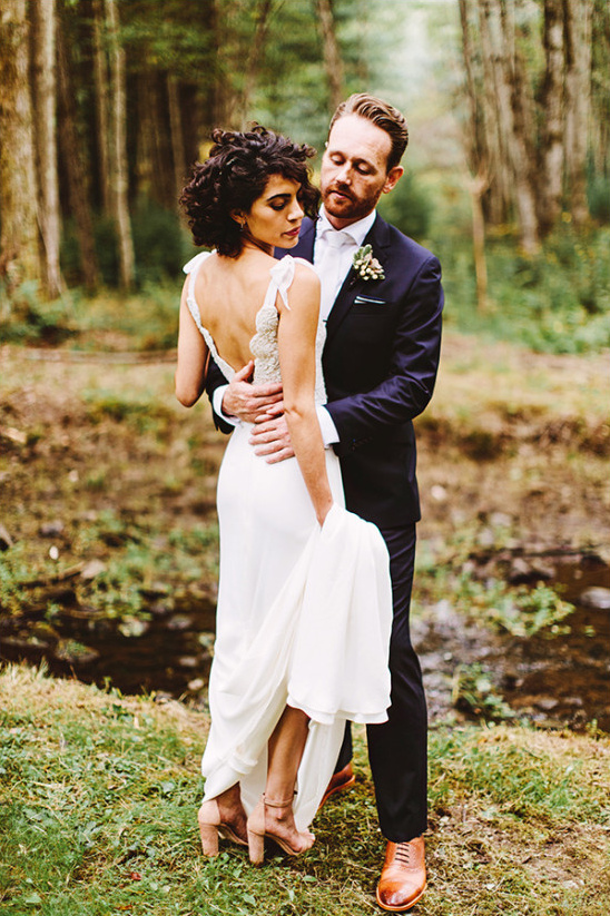 Romantic bride and groom embracing in a forest