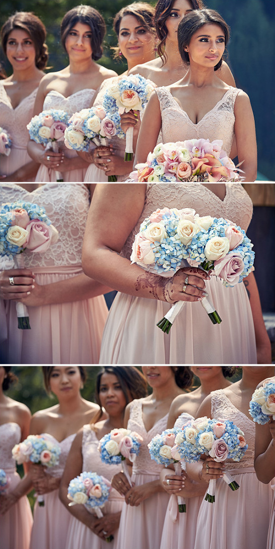 Bridesmaids in pink dresses holding flower bouquets