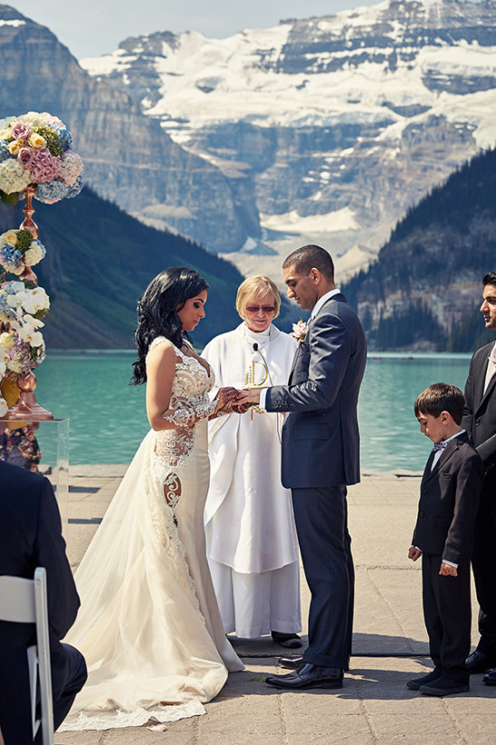 Lake Louise wedding ceremony exchanging rings