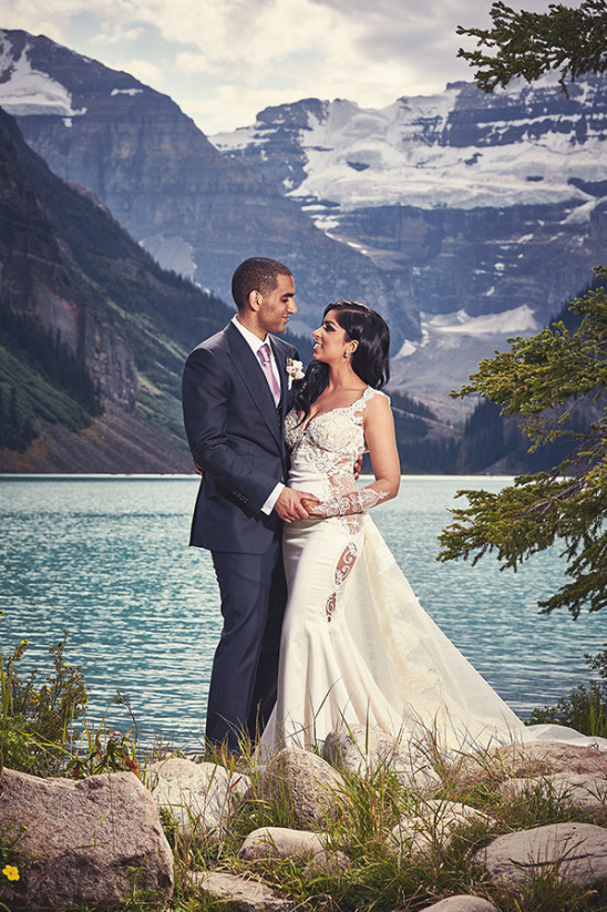 Bride and groom at stunning mountain lake wedding