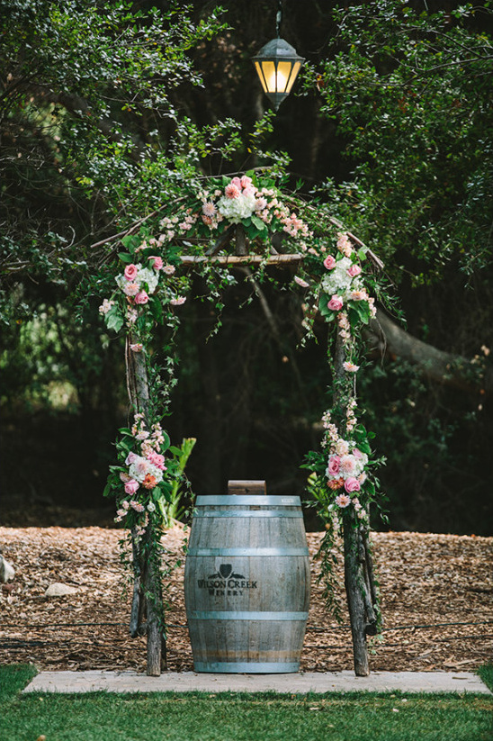 rustic flower covered ceremony arch