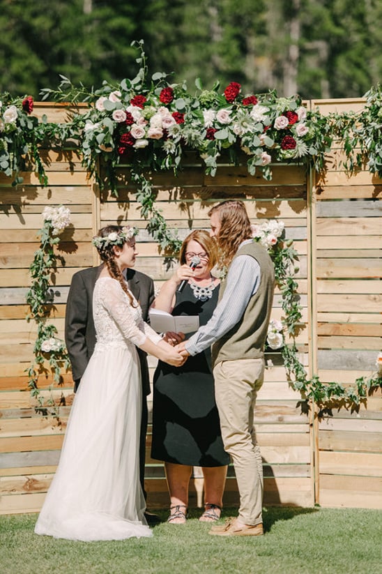 wood and flower wedding ceremony backdrop