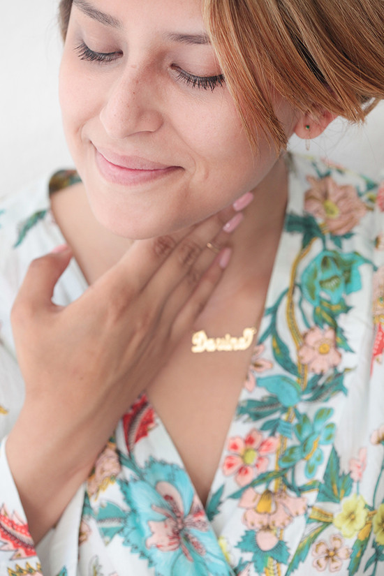 Woman in floral robe wearing a gold necklace