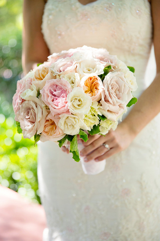Bride holding a beautiful rose bouquet on her wedding day