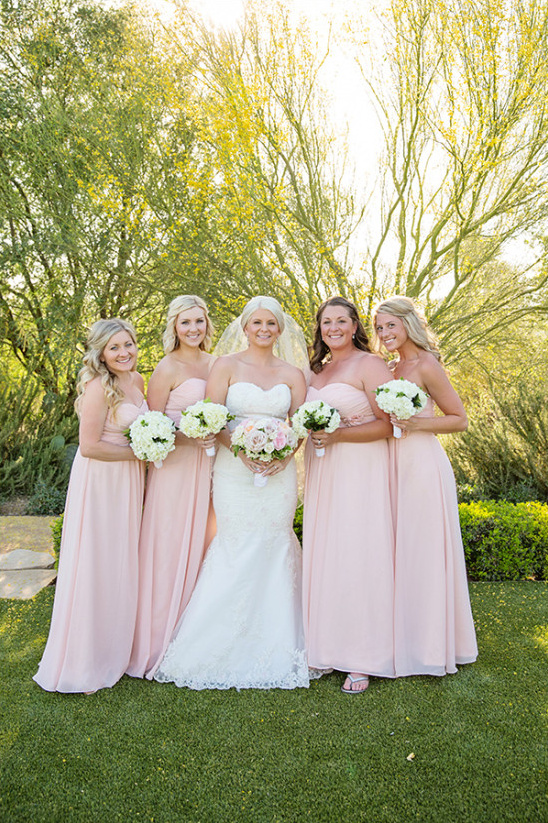 floor length pink bridesmaid dresses with white bouquets