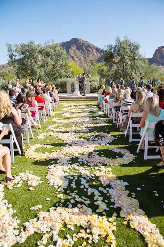 Outdoor wedding ceremony with rose petal aisle design