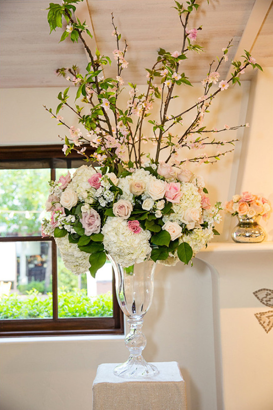 Elegant pink and white floral centerpiece in glass vase
