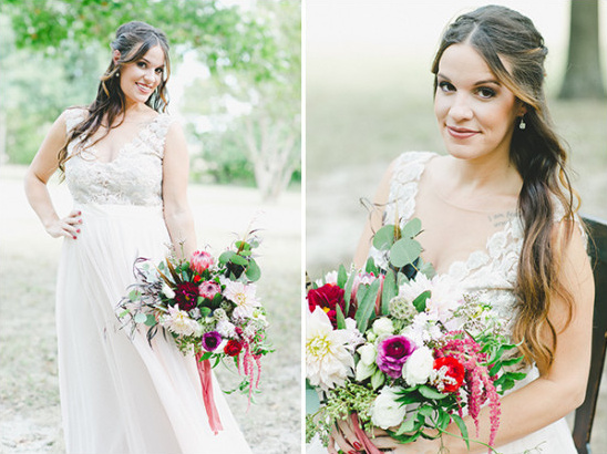 Beautiful bride in lace gown holding a vibrant bouquet
