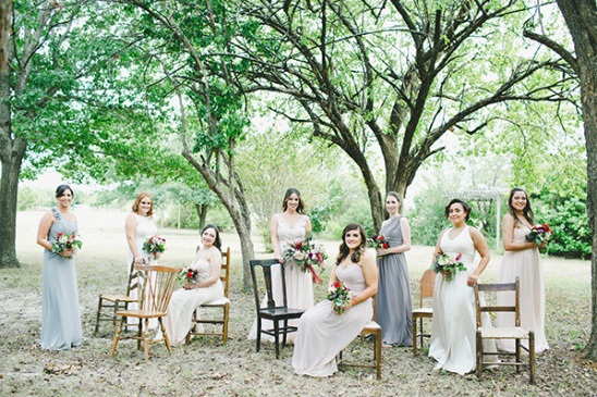 Bridesmaids pose with bouquets outdoor wedding party