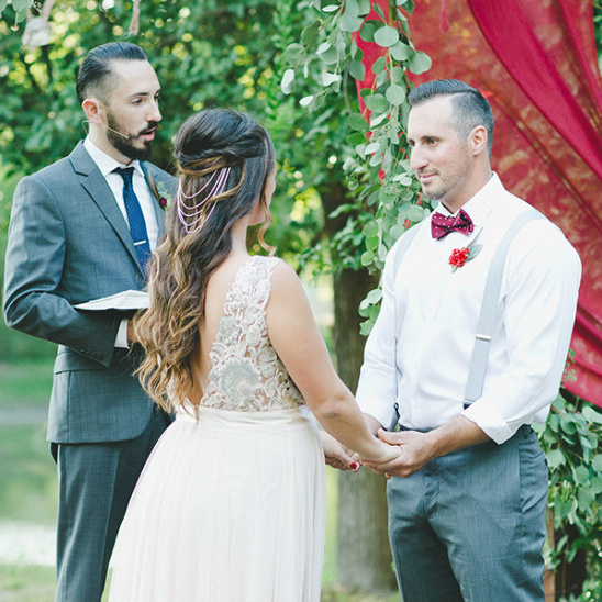 Bride and groom exchanging vows at outdoor ceremony