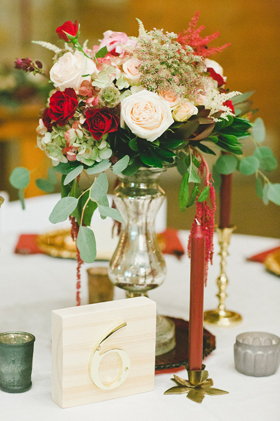 Elegant wedding table centerpiece with flowers and number six