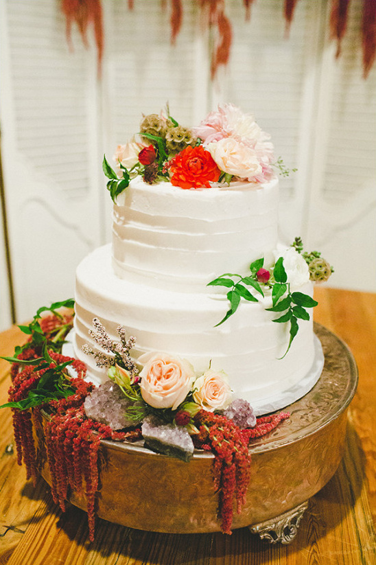 Two tier wedding cake with floral and crystal accents