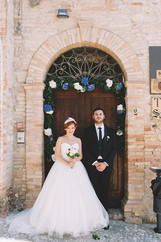Bride and groom posing at rustic Italian wedding