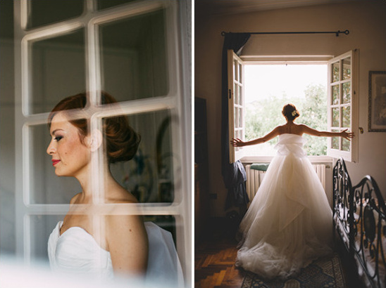 Bride in wedding dress looking out window
