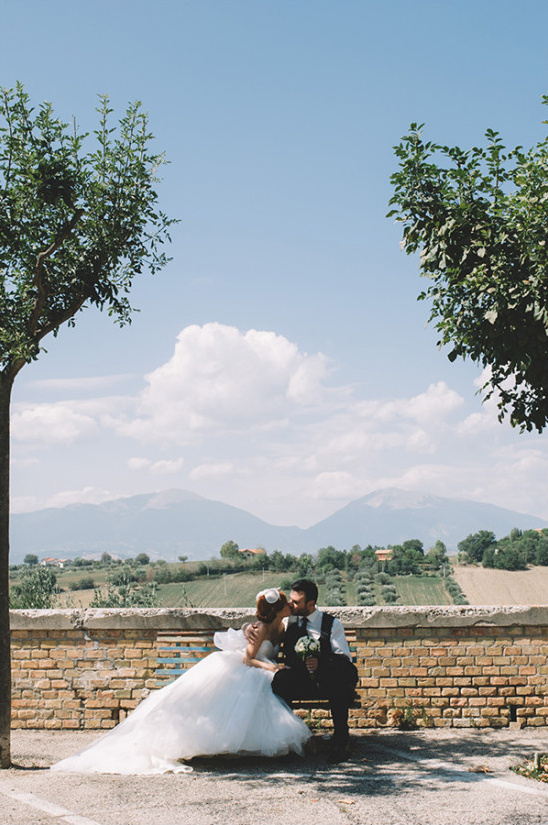 Bride and groom kiss on their wedding day landscape view
