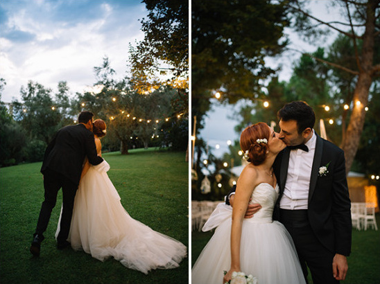 Romantic wedding couple kissing under fairy lights