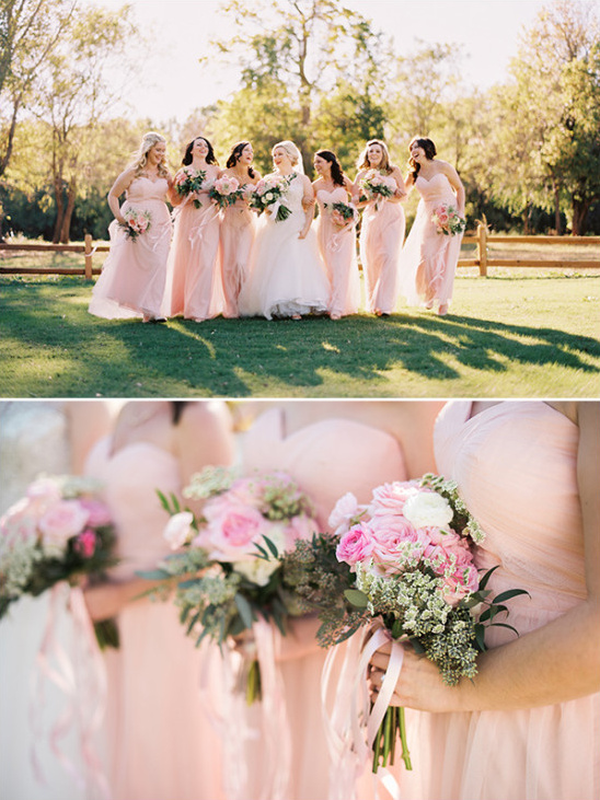 Pink bridesmaids and bride laughing outdoors at wedding