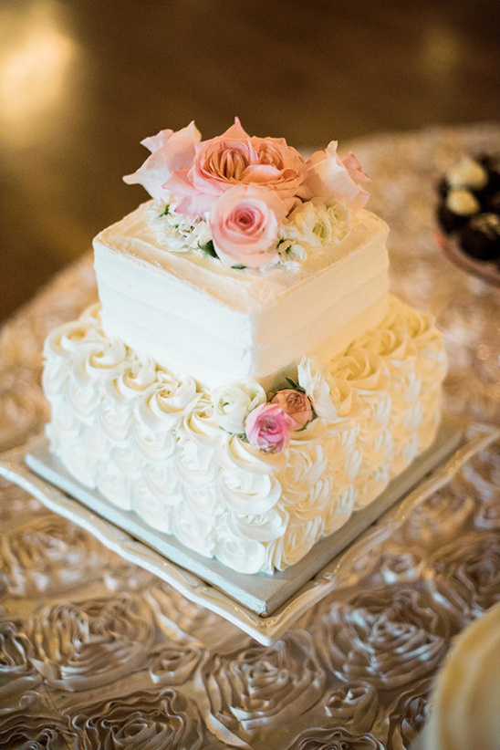 Elegant two tiered wedding cake with pink roses