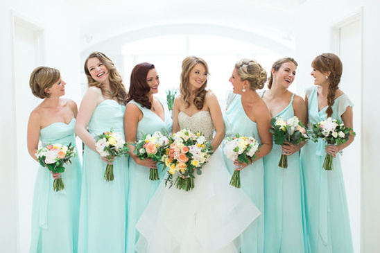 Bride with bridesmaids in light blue dresses and bouquets