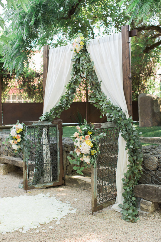 Rustic outdoor wedding arch with floral decorations