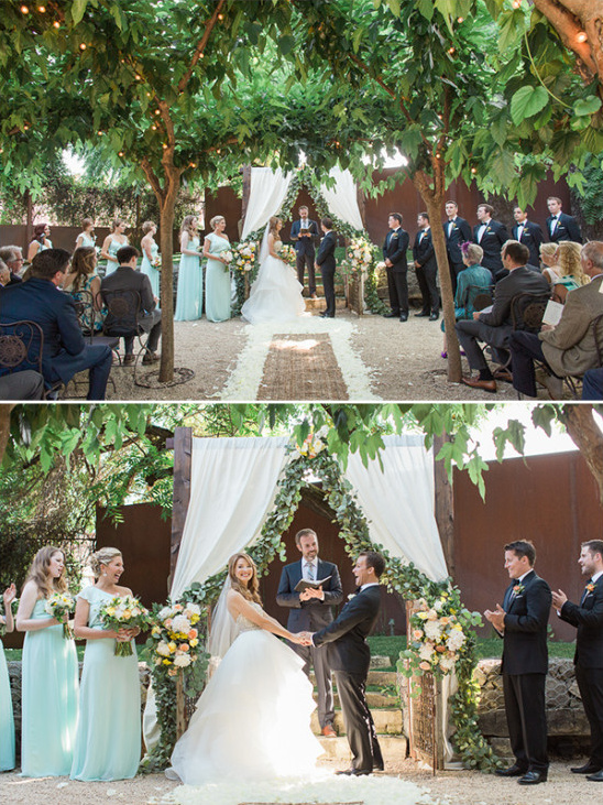 Outdoor wedding ceremony under leafy trees and floral arch