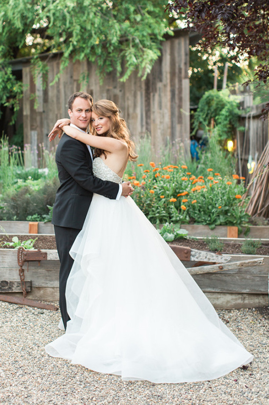 Happy couple embracing on their wedding day outdoors