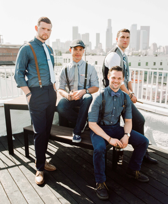 Men in suspenders with Los Angeles skyline backdrop