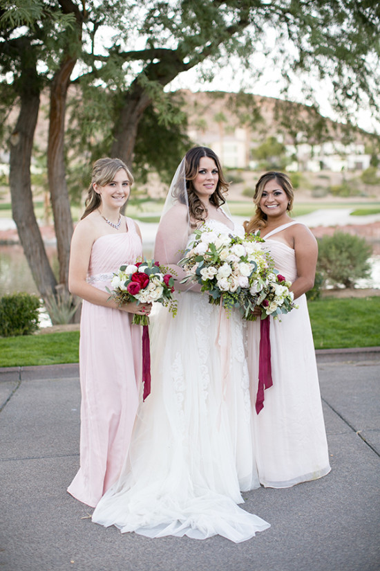 soft pink bridesmaids with red and white bouquet