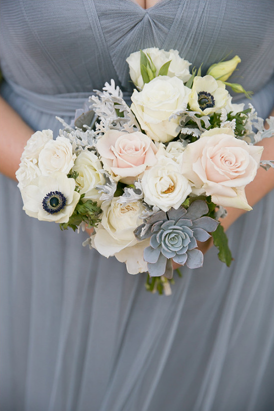 Bridal bouquet of roses and succulents in a gray dress