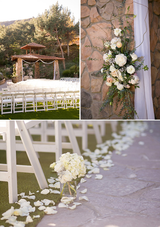 Outdoor wedding ceremony setup with white chairs and flowers