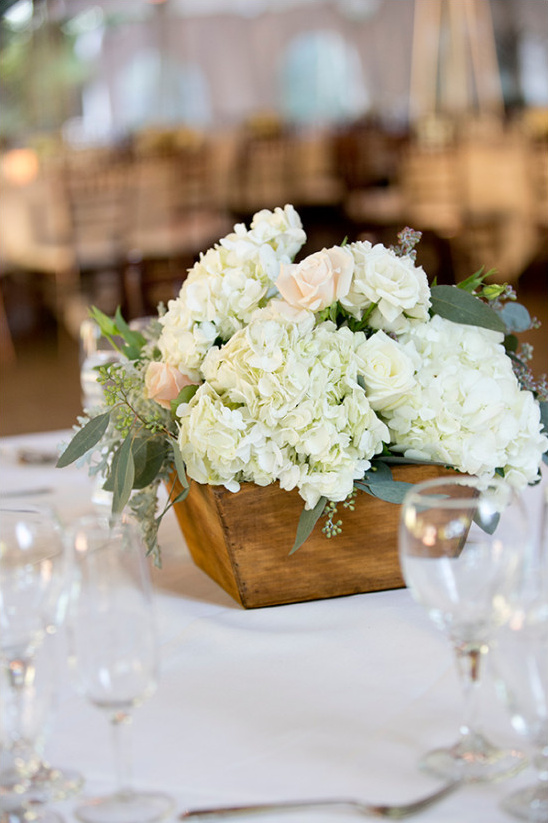 Wedding centerpiece with white flowers and wood box