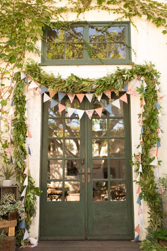 bunting and greenery garland ceremony backdrop