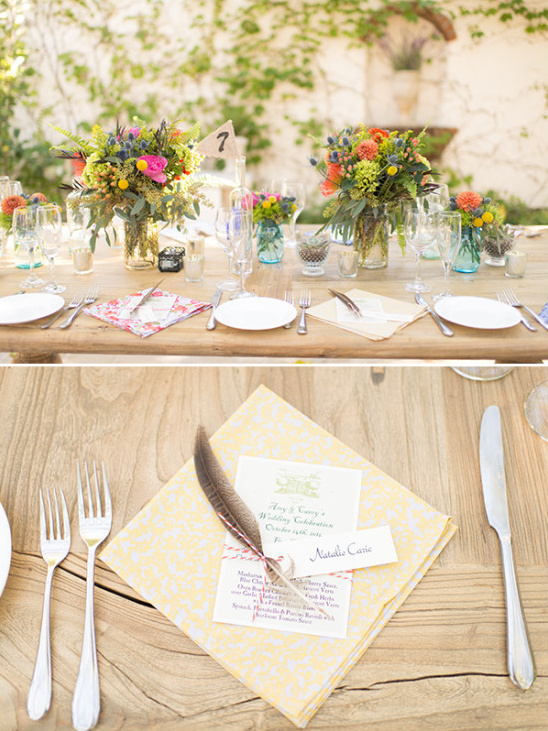 Outdoor wedding table setting with floral and feather details