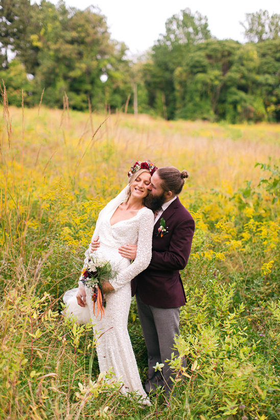 Bride and groom embrace in a golden field wedding day