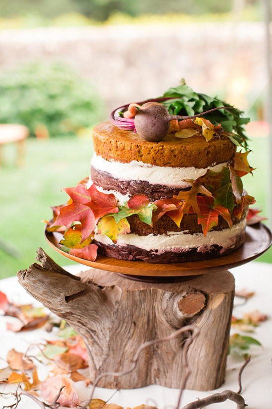 Rustic wedding cake with autumn leaves and beet garnish