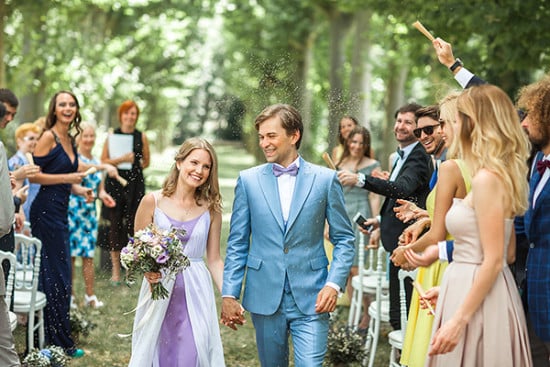 newlyweds with lavendar seeds confetti