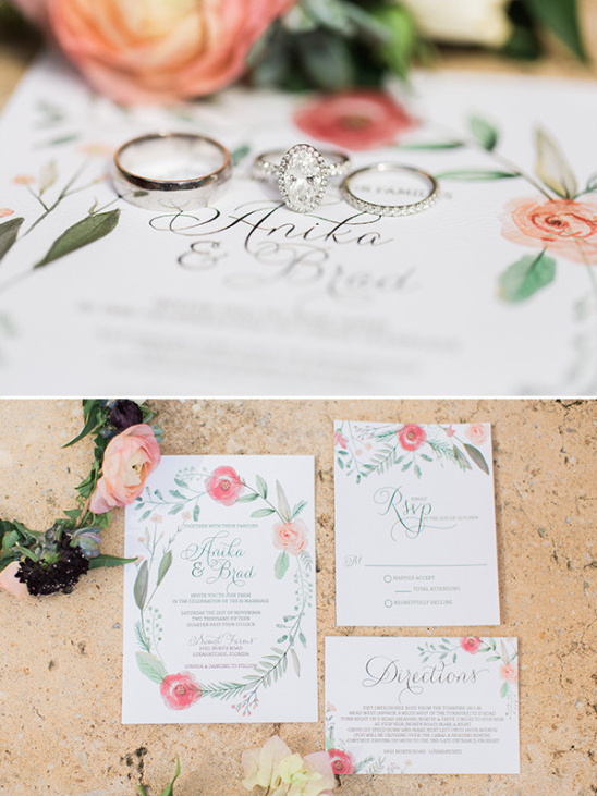 Wedding rings and invitation with floral design detail
