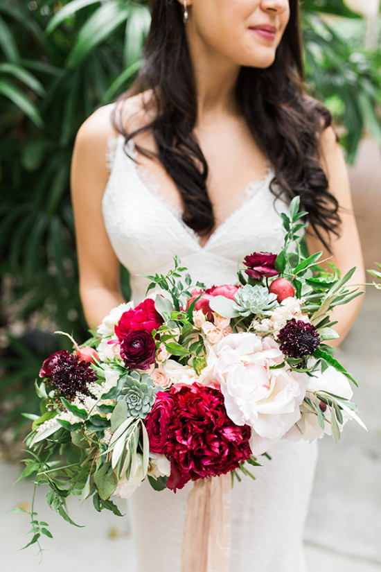Bride holding a stunning red and white wedding bouquet