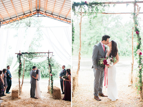 Rustic barn wedding ceremony: bride and groom kiss